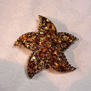 Regency Austrian yellow/gold colored rhinestone star brooch